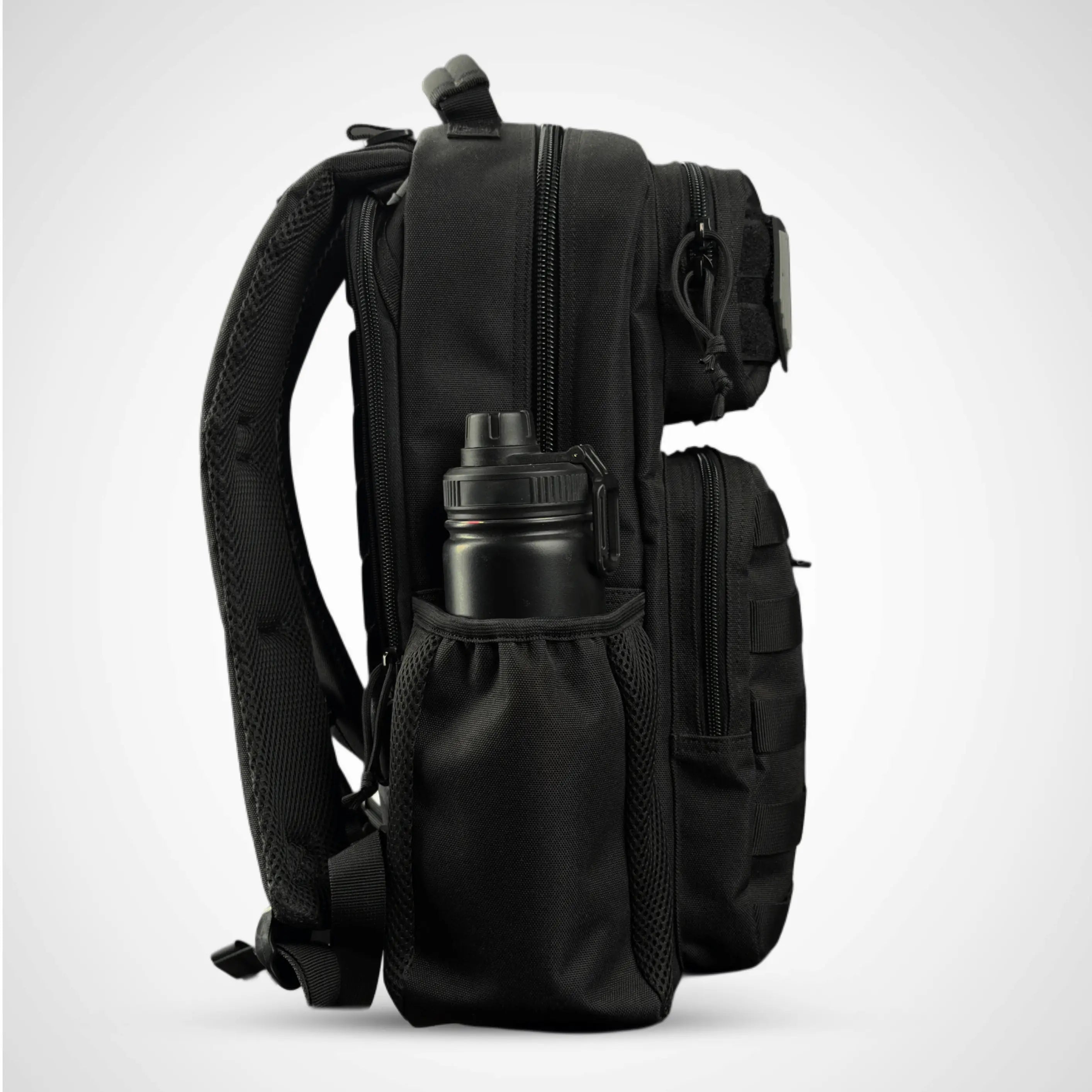 side view of HONO black tactical backpack with bottle holder pocket 